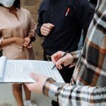 Trois personnes signent un contrat de travail au bureau